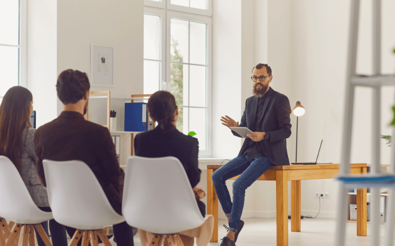 study online business administration degree Man talking on phone with a world sphere and emoji people linked together